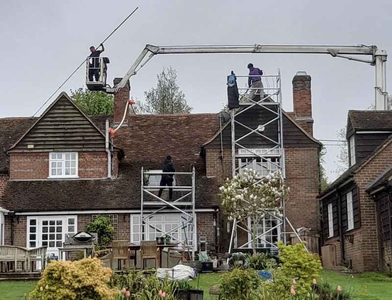 The Roof Moss Cleaners using cherry picker and scaffolding to clean roof safely and professionally in Marlborough, Wiltshire